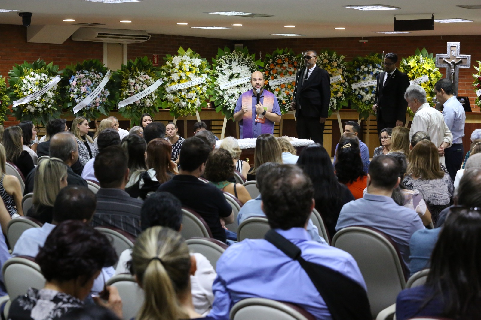Imagem aberta do velório do juiz no Pleno do TJTO; com muitas pessoas e ao fundo muitas coroas de flores