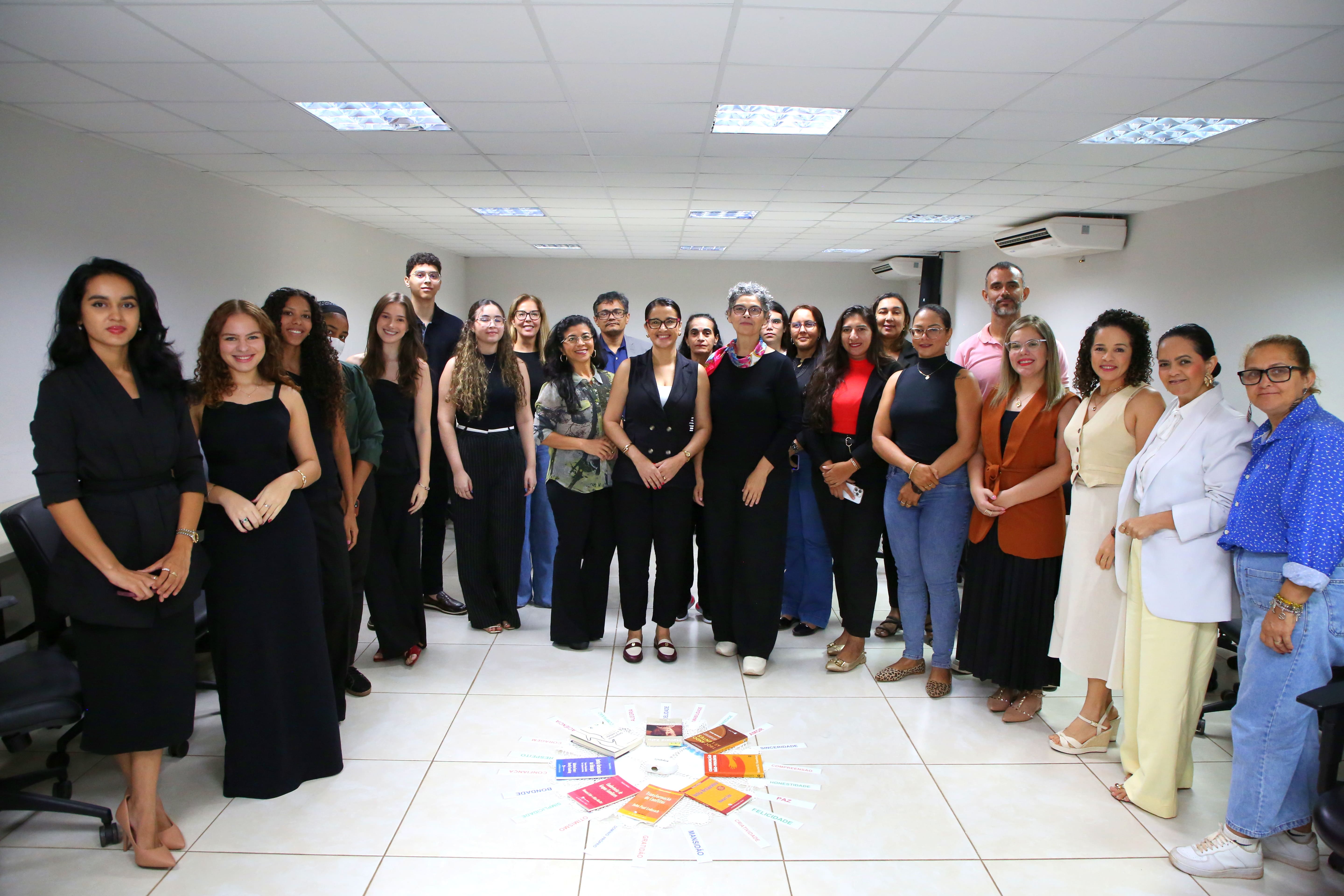 Grupo de pessoas em pé posam para foto
